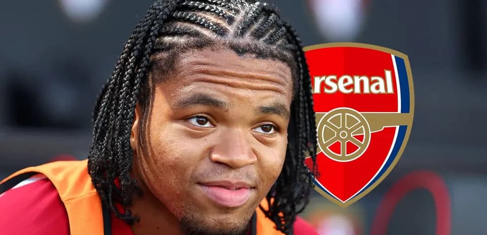 Player with braided hair wearing Arsenal training kit