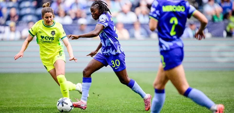 Players competing for the ball in NWSL match