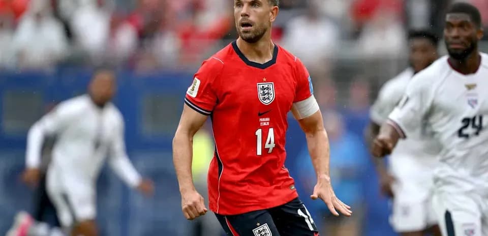 Player in red England jersey during match action