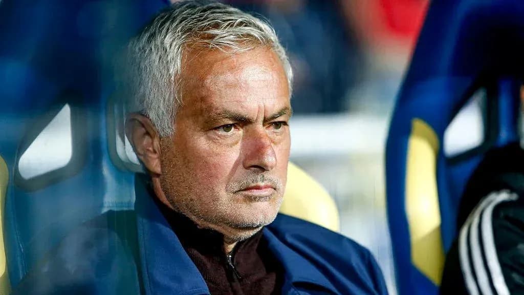 Coach sitting on bench during a match