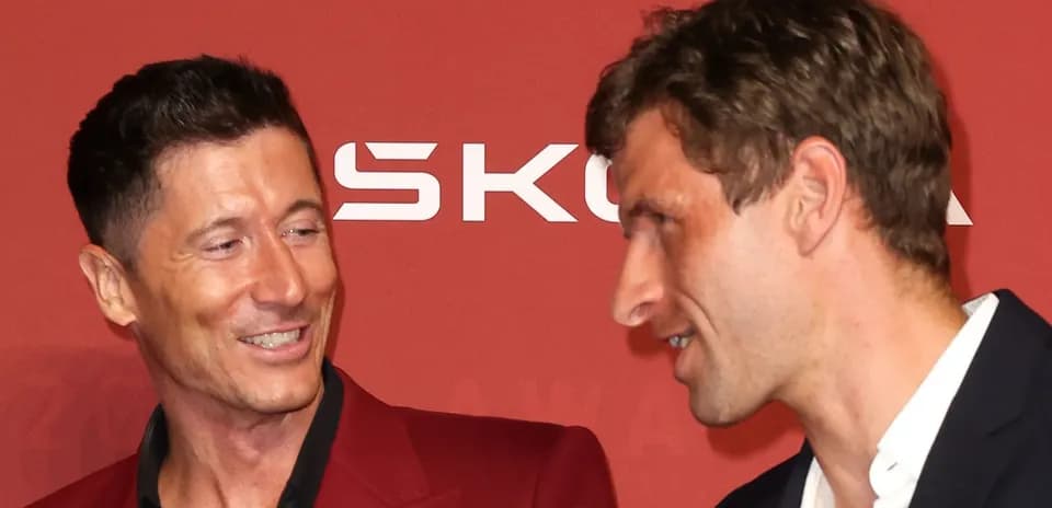Two football players interacting at an award ceremony