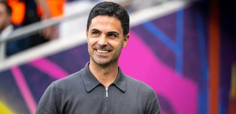Manager smiling before a match at the stadium