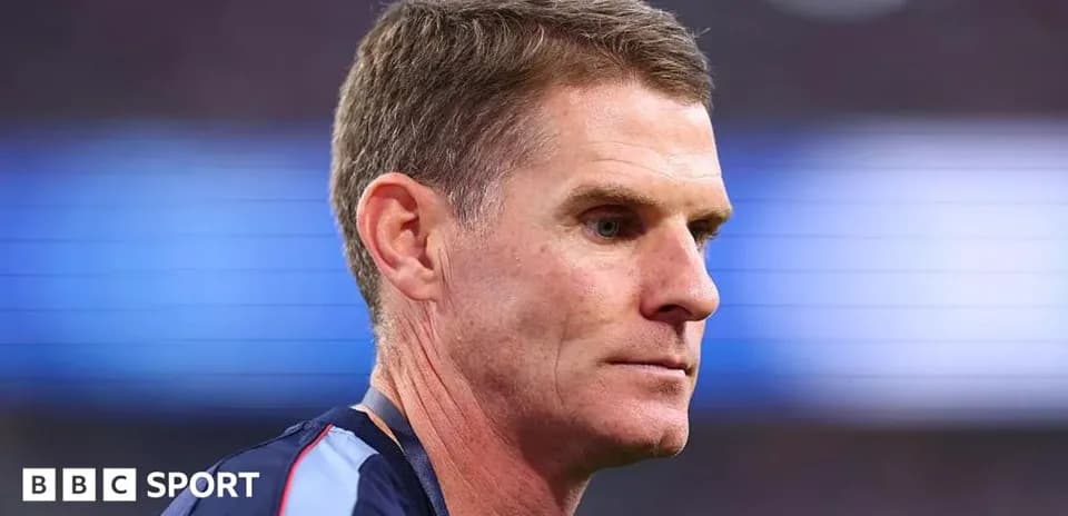 Coach focused during match preparation on sidelines