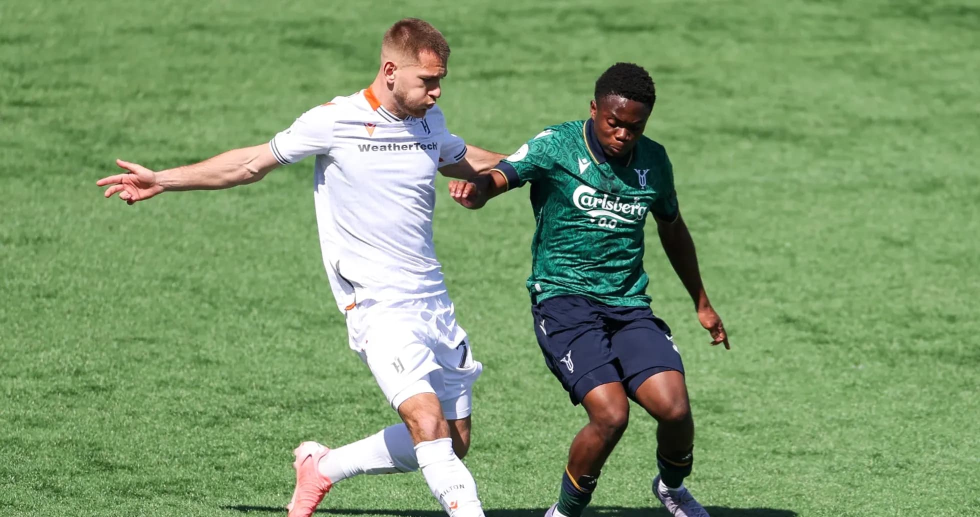 Players contesting the ball during Forge vs York United