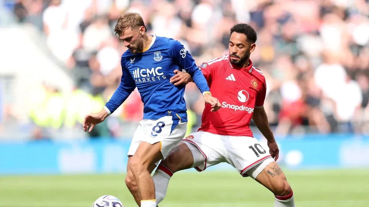 Everton player tackled by Manchester United player