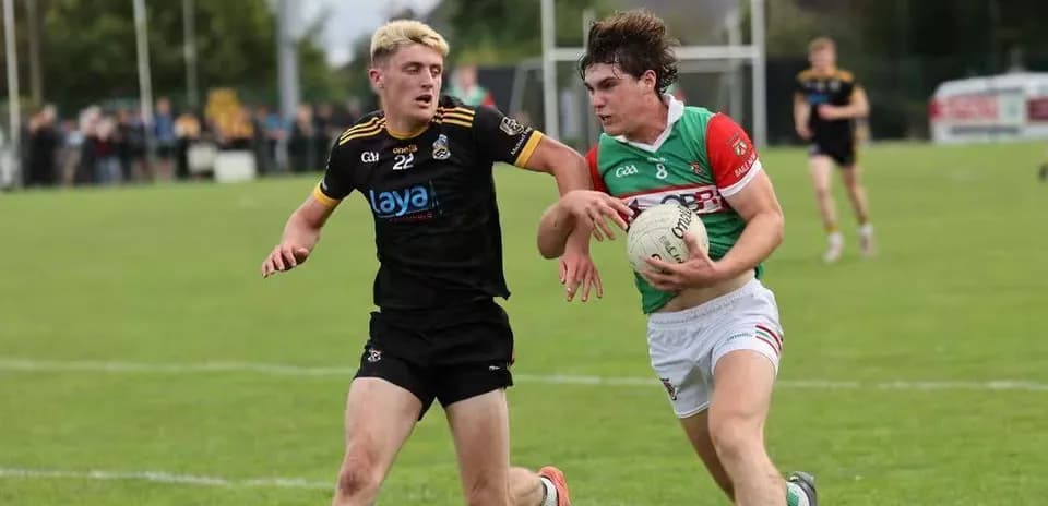 Two players competing for a football on field