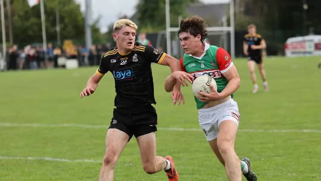 Two players competing for a football on field