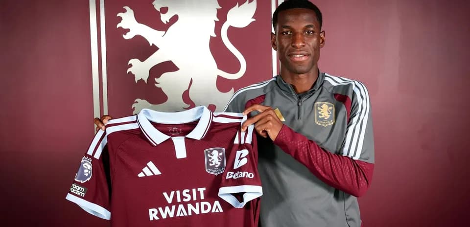 Player holding Aston Villa jersey at press event
