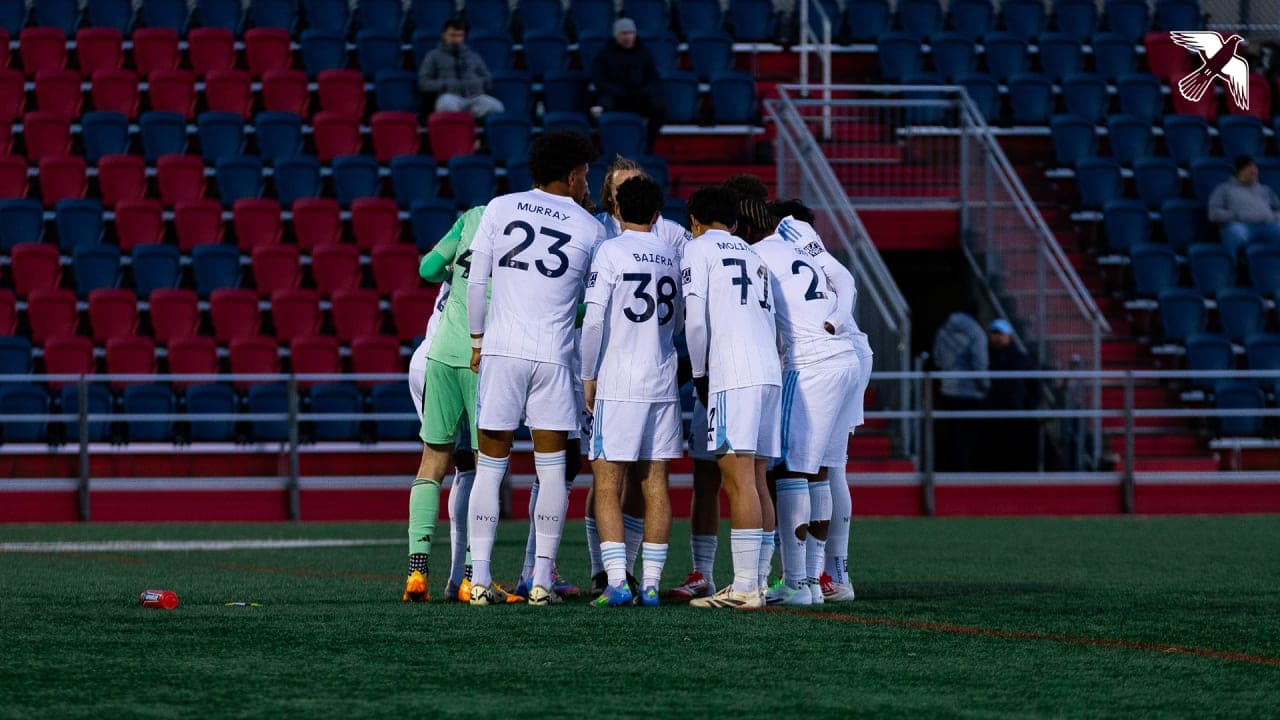 New York City II players huddling together