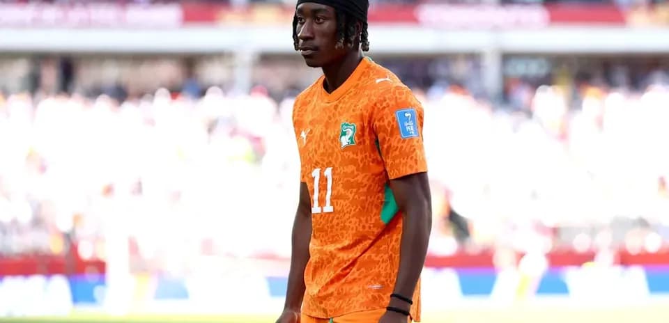 Player wearing orange jersey during match warm-up