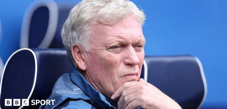 Coach sitting on bench during match