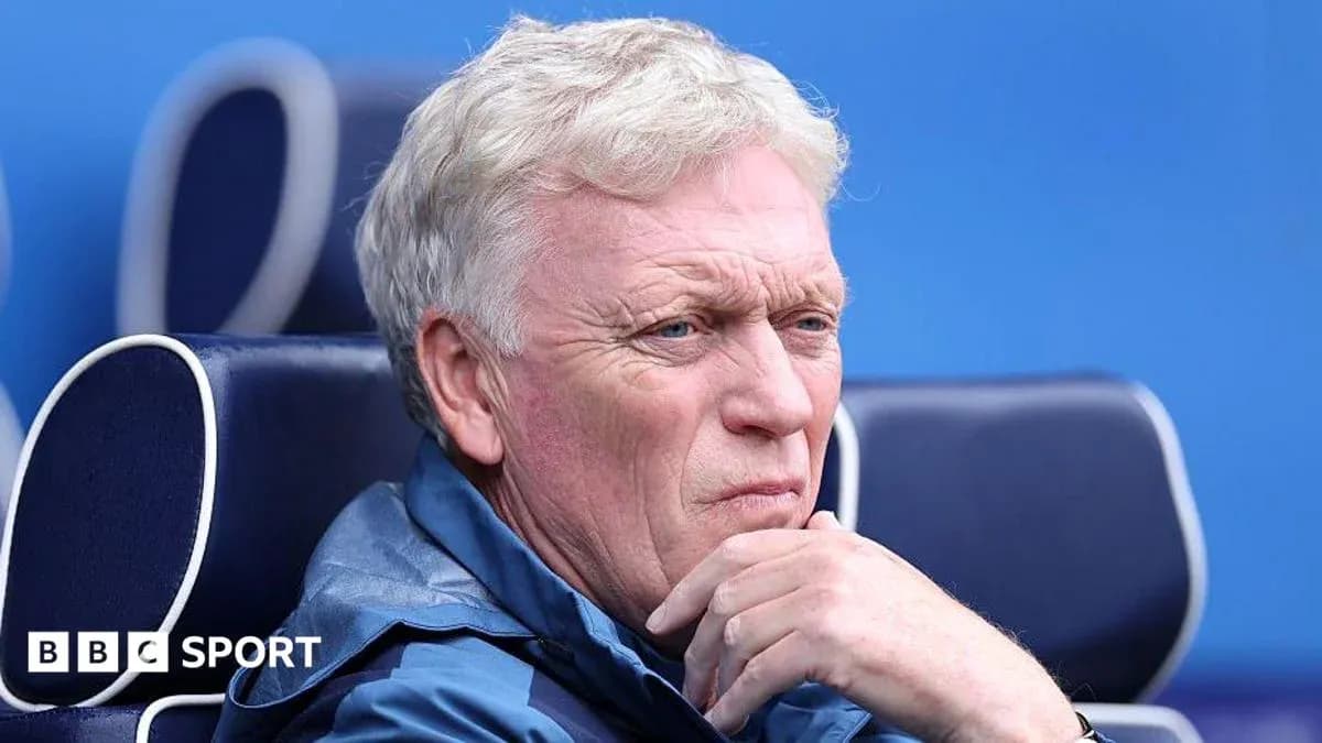 Coach sitting on bench during match