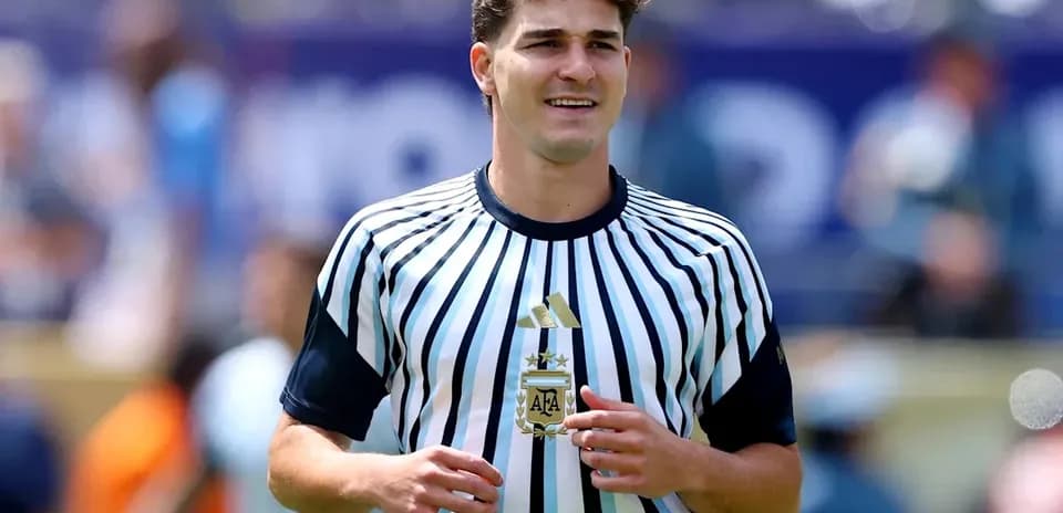 Player in striped jersey holding a trophy
