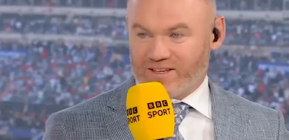 Sports commentator speaking into microphone on set