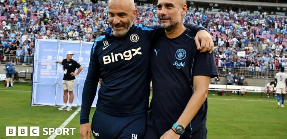 Two coaches walking off the field after match