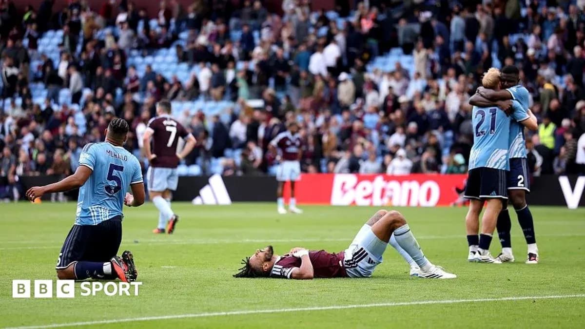Players reacting after match, one lying on the ground