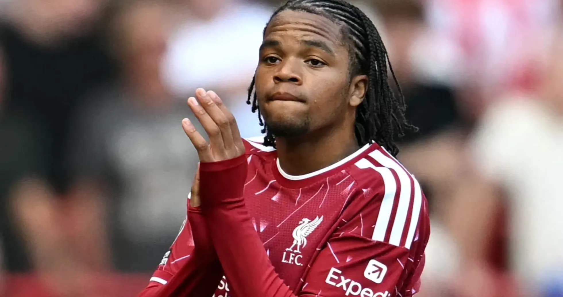 Player in Liverpool jersey applauding fans