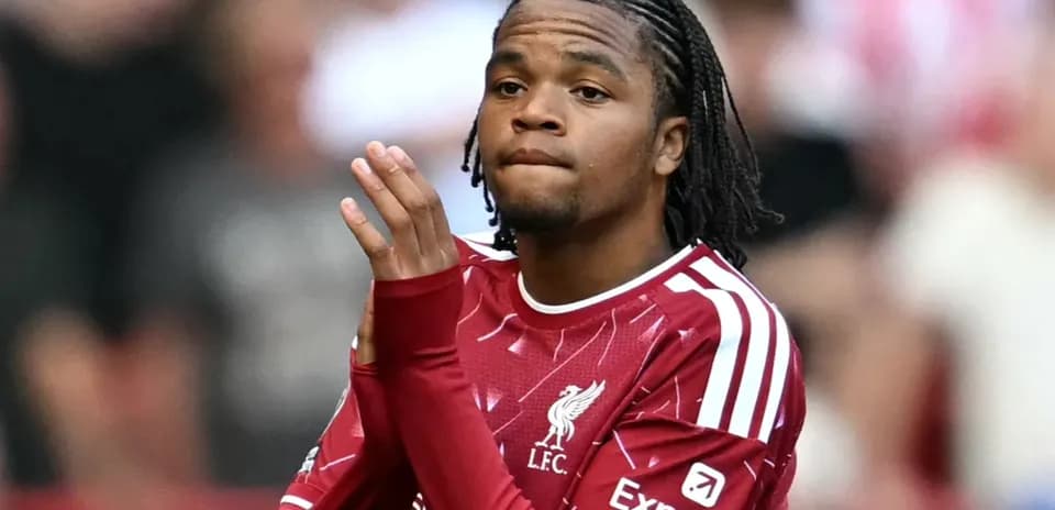 Player in Liverpool jersey applauding fans