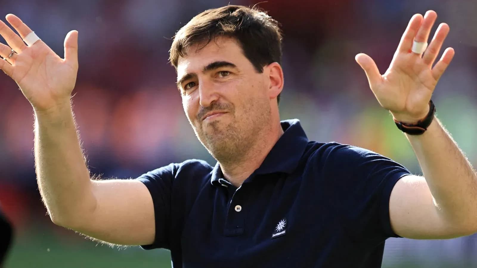 Coach waving to fans after the match