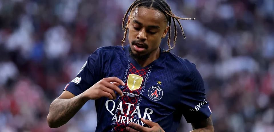 Player adjusting badge on PSG jersey during match