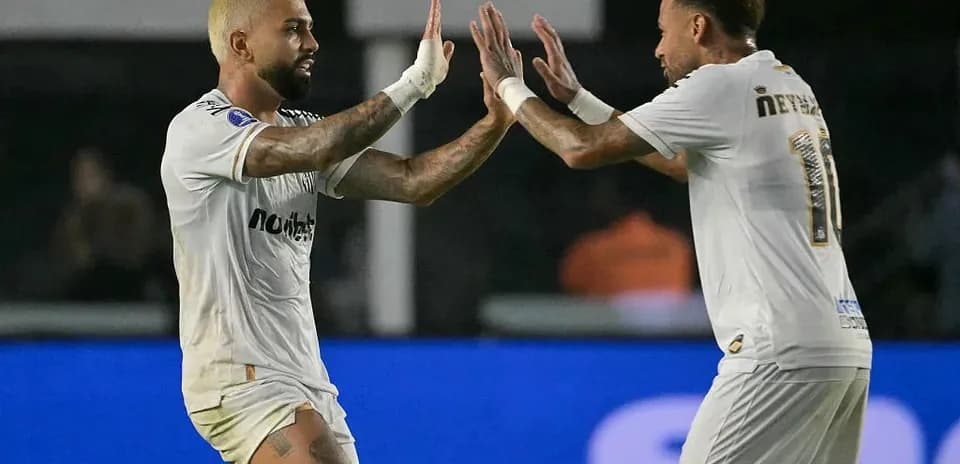 Two players celebrating a goal on the field