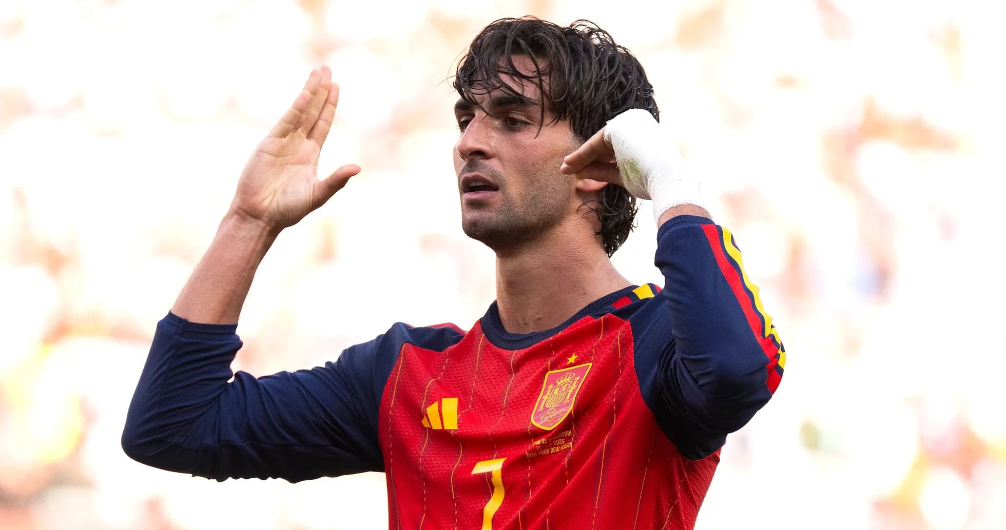 Player in Spain jersey gesturing during match
