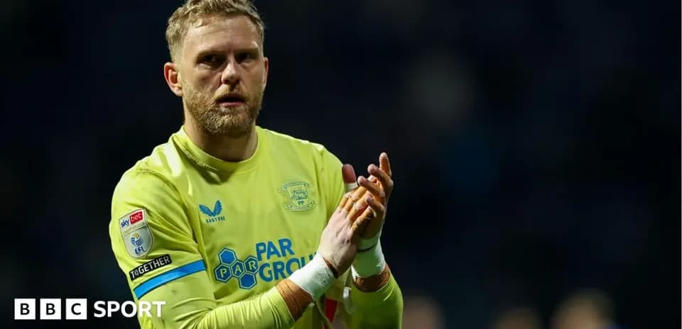 Goalkeeper clapping after match in yellow kit