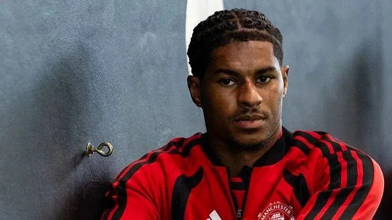 Player in Manchester United training gear posing indoors