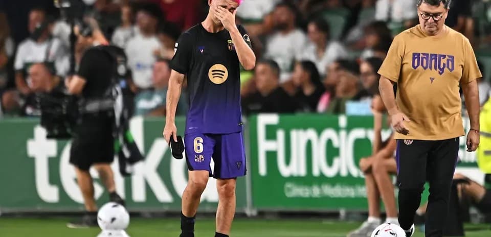 Player walking off field with head down during match