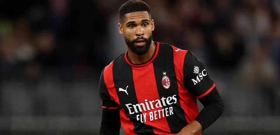 Player in AC Milan jersey during match action