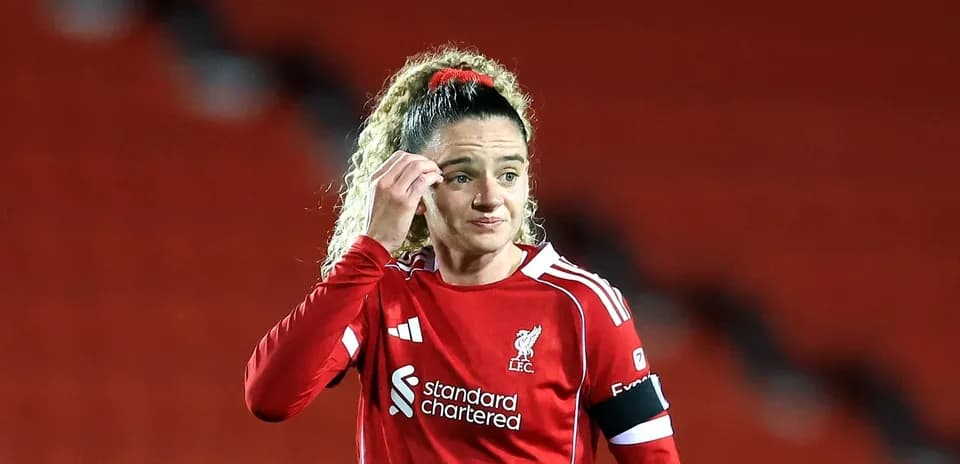 Liverpool player adjusting hair during match
