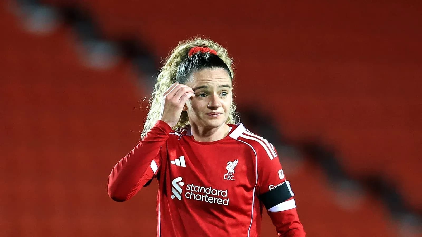 Liverpool player adjusting hair during match