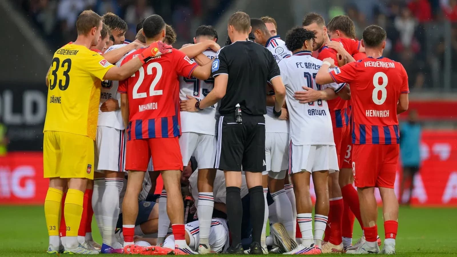 Players and referee gathered during match confrontation