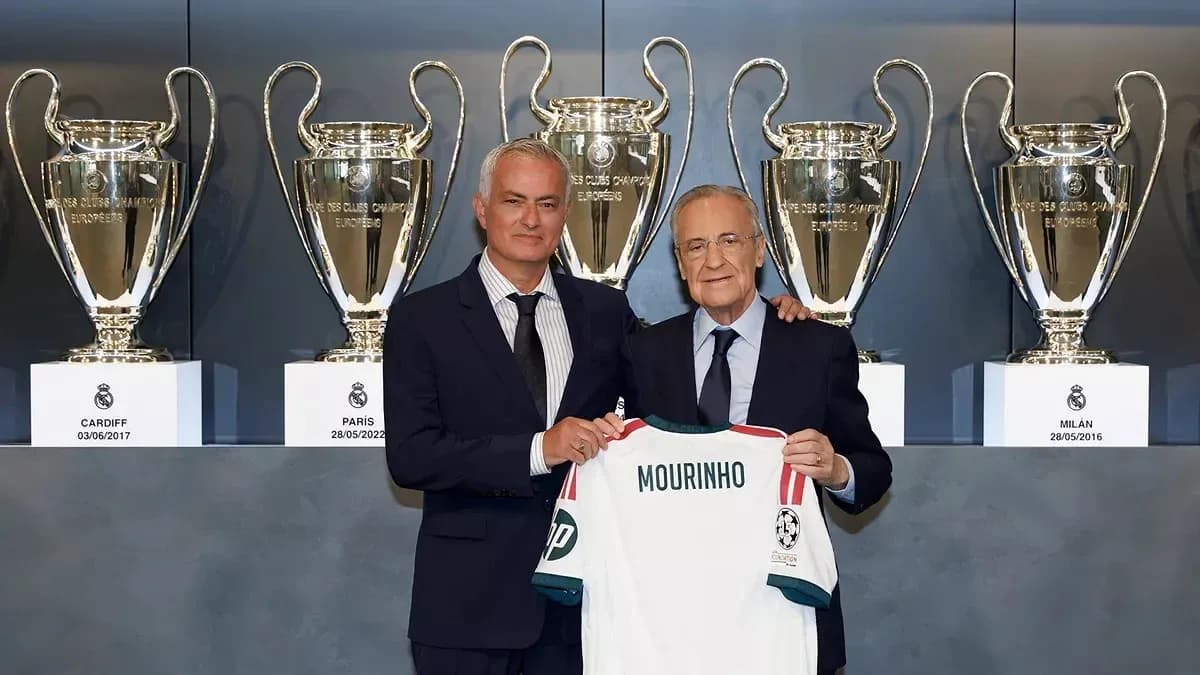 Jose Mourinho holding a jersey with Florentino Perez