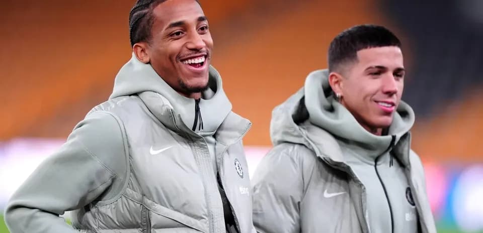 Two football players smiling in training jackets