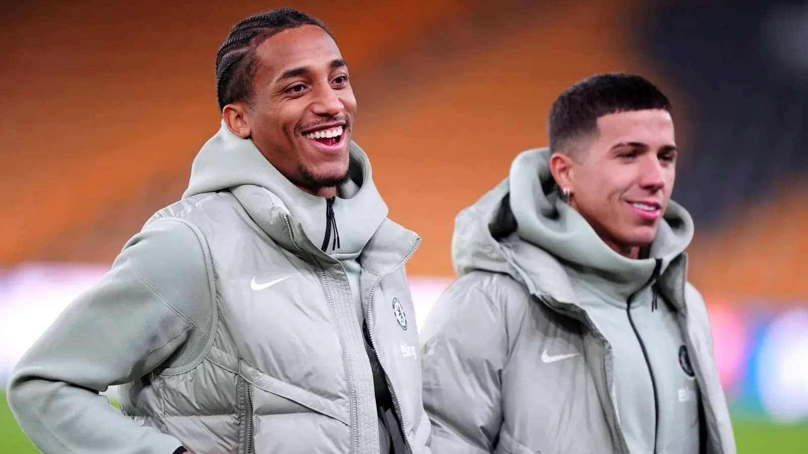 Two football players smiling in training jackets
