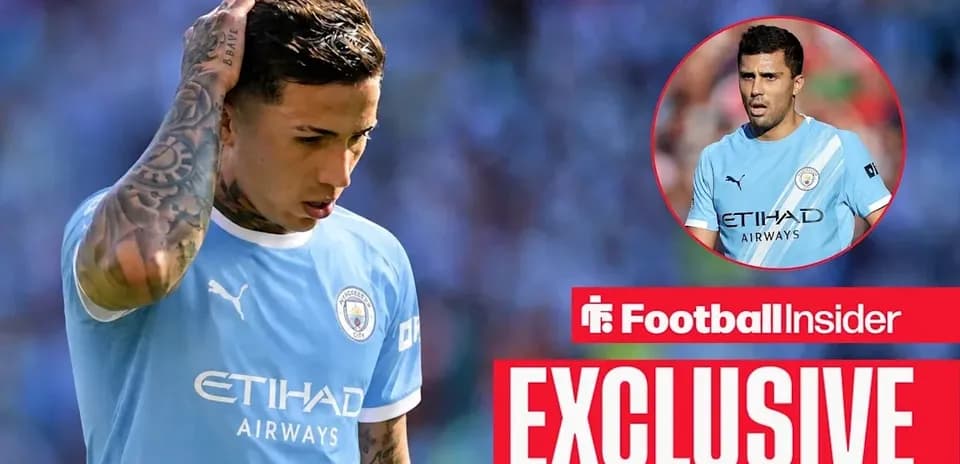Player looking down while wearing Manchester City jersey