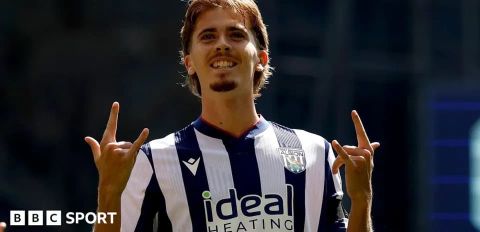 Player celebrating with hand gesture in team jersey