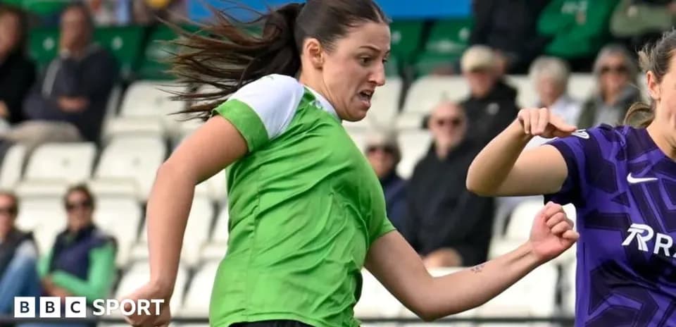 Player in green jersey dribbling past opponent