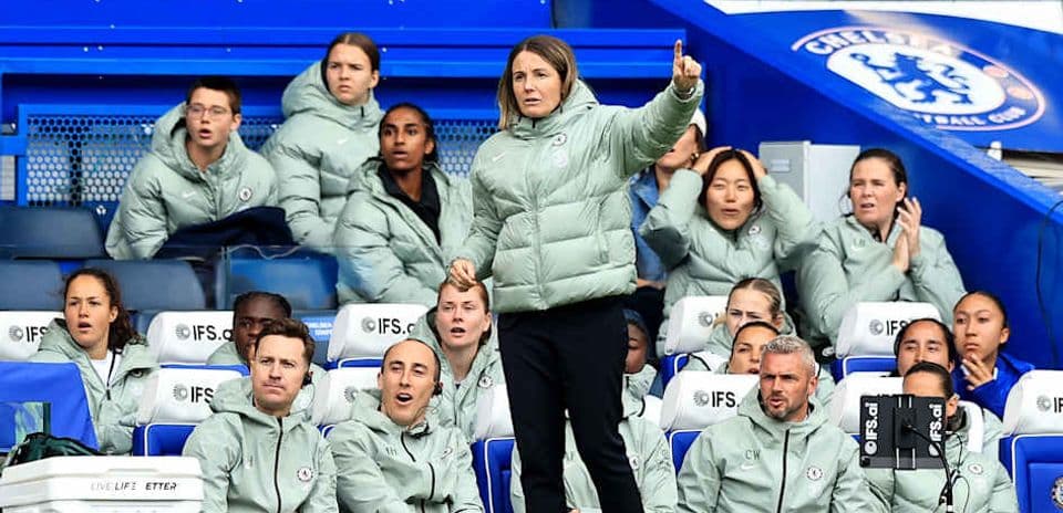 Coach directing players from the sideline during match
