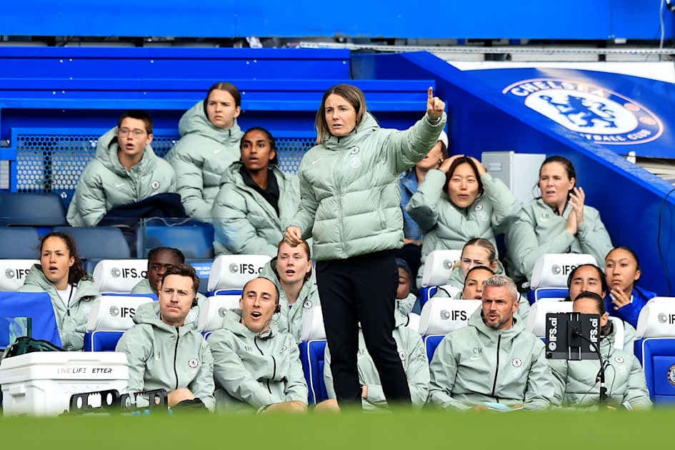 Coach directing players from the sideline during match