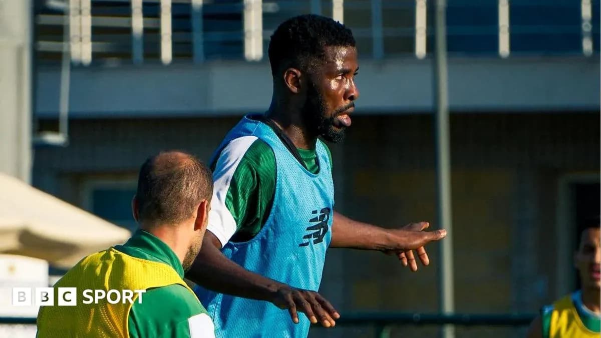 Player training on pitch with teammates nearby