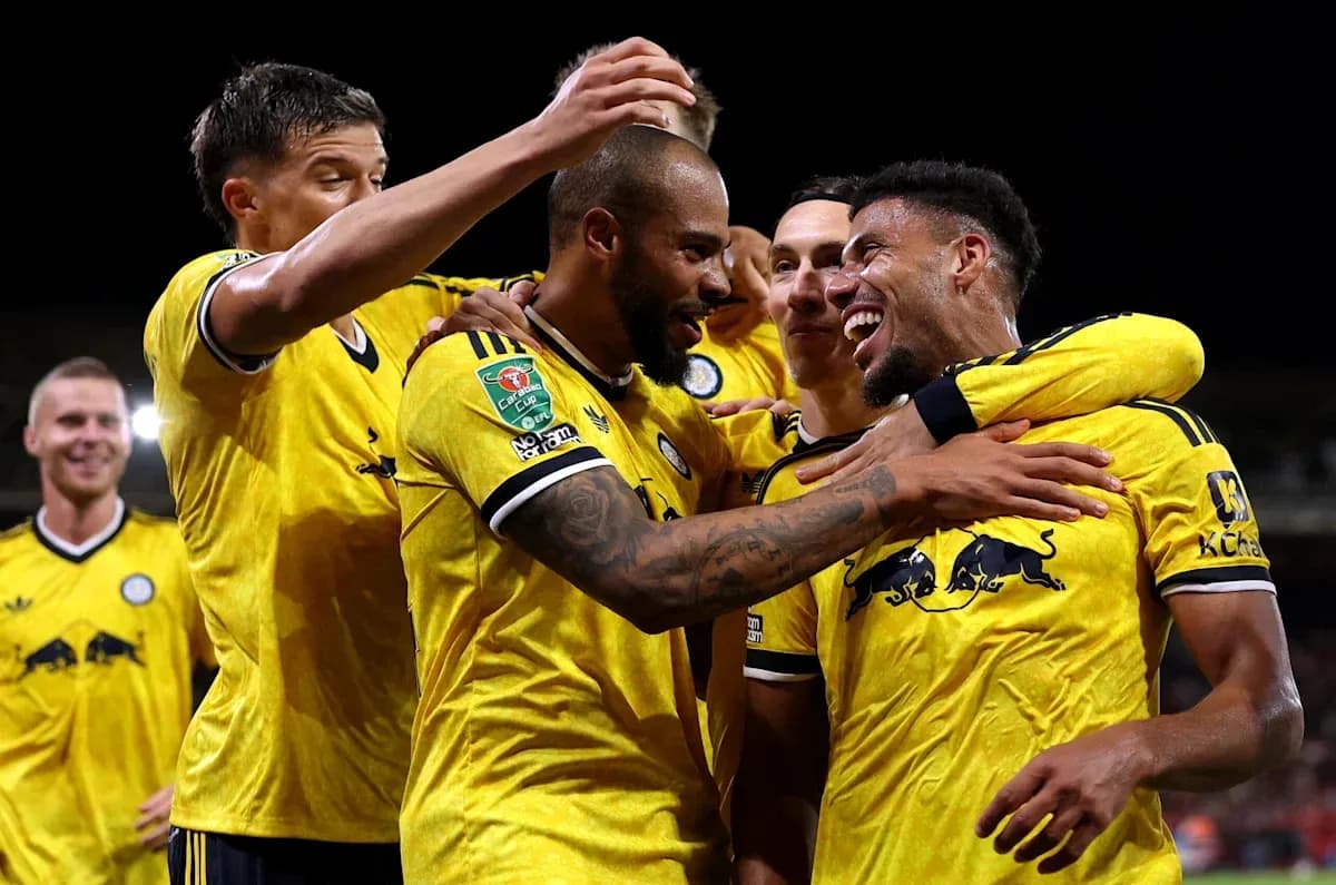 Players celebrating a goal in yellow team jerseys