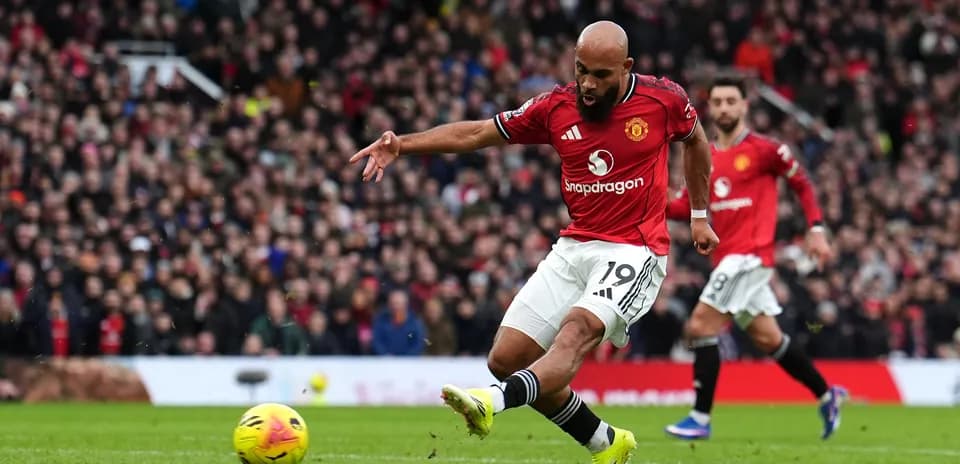 Manchester United player shooting at goal