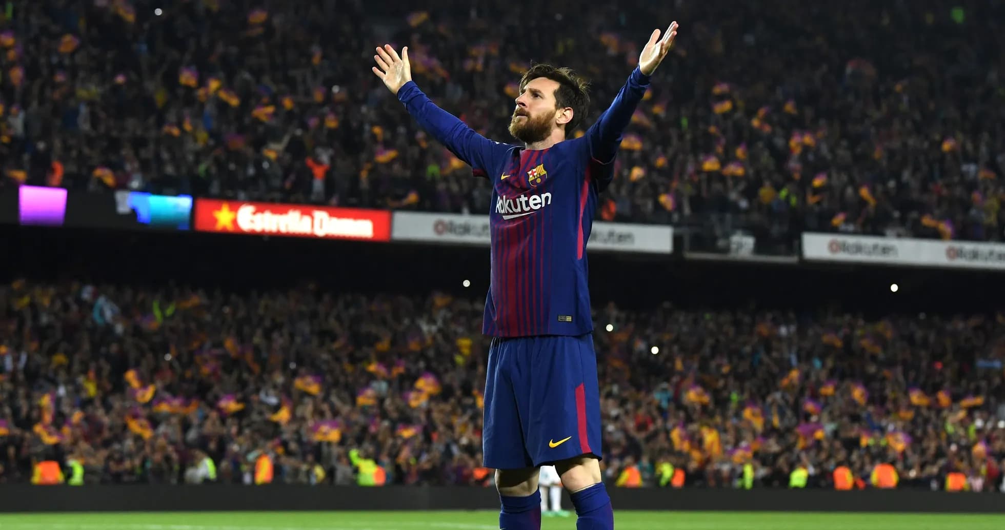 Player celebrating with arms raised in stadium