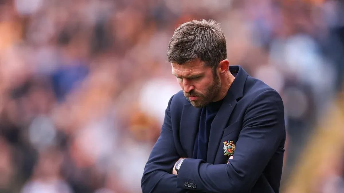 Coach with arms crossed during a match