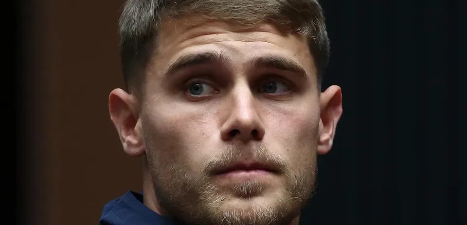 Athlete in team jacket during press event