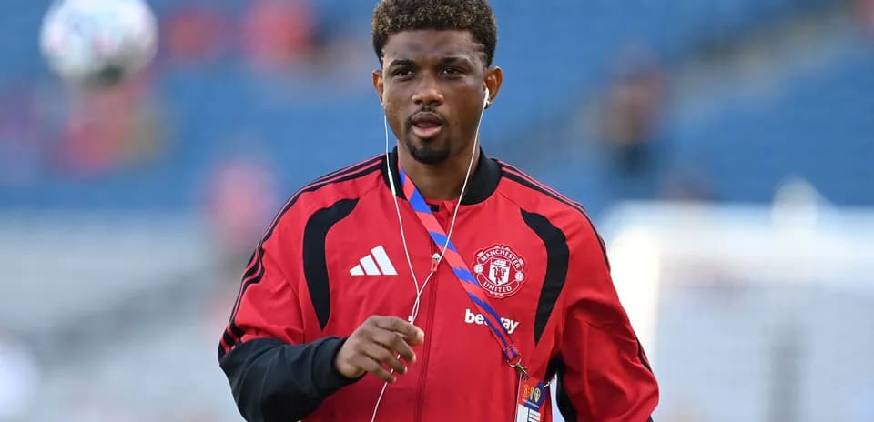 Player warming up in Manchester United training kit