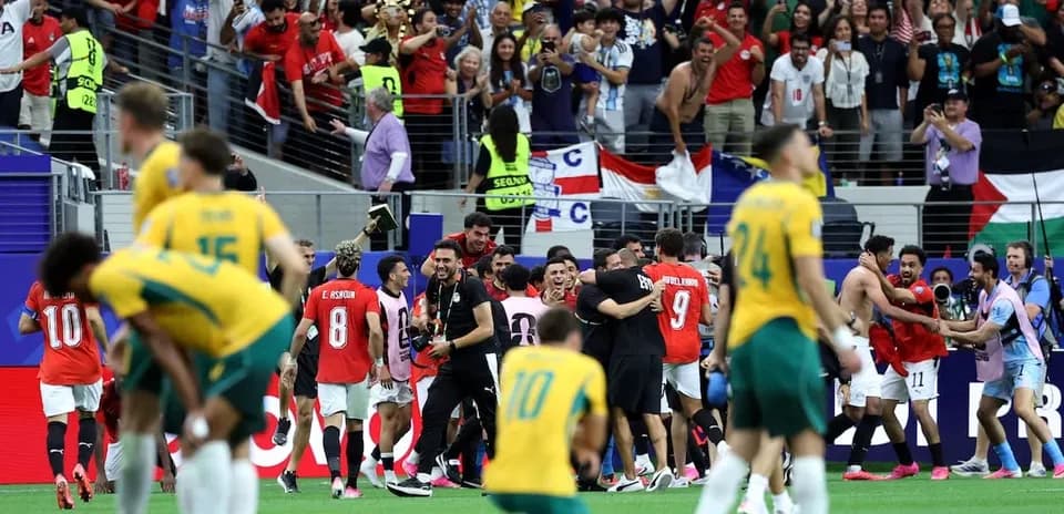Players celebrating victory with fans in stadium