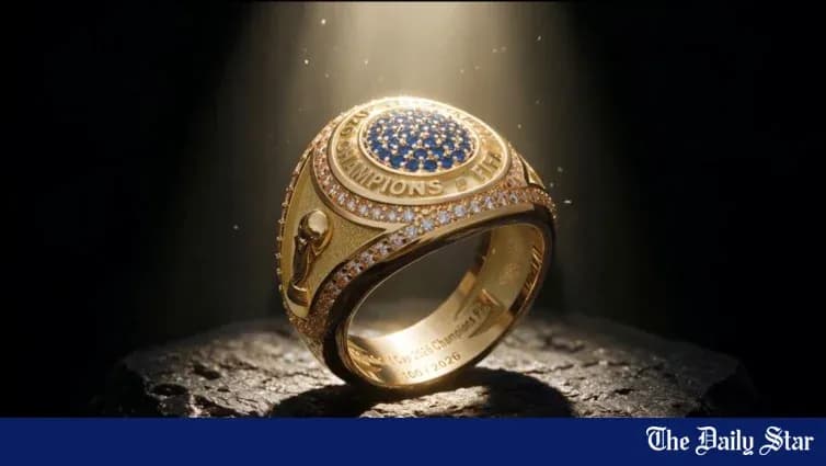 Gold championship ring with blue gemstones displayed
